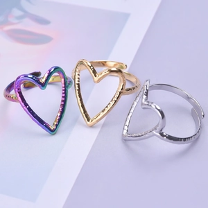 Three hammered heart-shaped adjustable rings in silver, gold and rainbow finishes