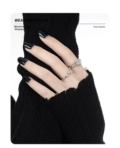 Detailed view of an S925 silver vine ring with milky white stone on a model hand