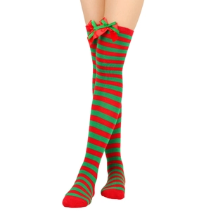 Detail of red and green striped over-knee Christmas socks with ribbon bow decorations