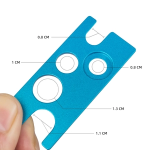 Blue metal essential oil bottle opener tool with multiple hole sizes for easy lid removal