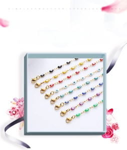 Set of seven colorful evil eye bracelets with gold plated chains and lobster clasps