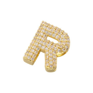 Detailed close-up of golden letter R pendant with sparkling cubic zirconia pavé stones