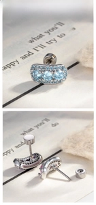 Macro view of silver micro-paved blue gemstone cartilage stud with screw-back closure