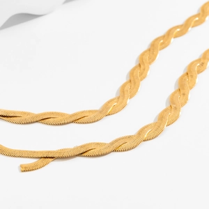 Detail der gedrehten doppelten Gold-Schlangenketten mit polierter reflektierender Oberfläche