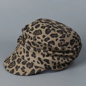 Detail shot of leopard print beret hat texture with pleated twill fabric and stitching