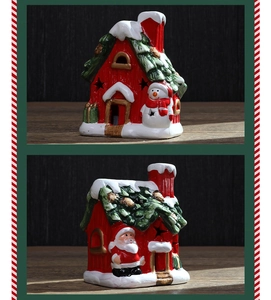 Close-up of ceramic Christmas house ornaments with Santa and snowman cut-out designs