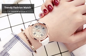 Detail of white leather strap watch with rose gold dial and matching roman numeral bracelet
