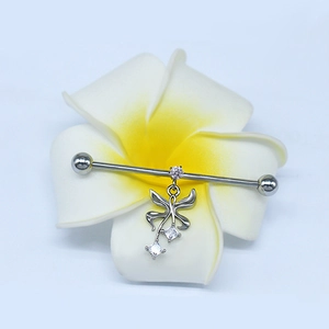 Industrial barbell earring with a crystal butterfly pendant on a tropical flower