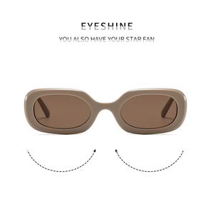 Detail view of oval retro sunglasses with thick khaki frames and dark brown lenses