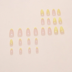 Pastel yellow gradient press on nails with delicate white floral patterns and almond shape