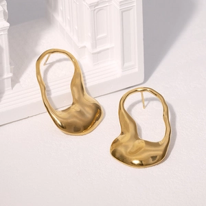 Minimalist irregular gold titanium steel earrings on a textured white surface