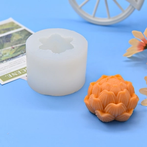 White silicone mold with finished 6-petal lotus flower candle for DIY craft projects
