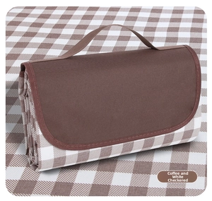 Detail of folded coffee white plaid picnic mat with waterproof oxford fabric and strap