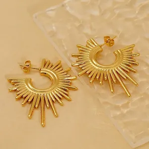 Golden irregular geometric sunburst stud earrings with polished ray pattern finish