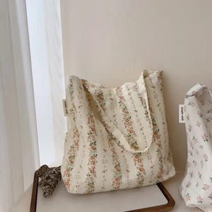 Detail of floral cotton tote bag with vintage flower patterns and simple wish fabric label