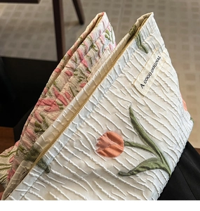 Detail of tulip embroidery on canvas cosmetic bag with premium gold zipper closure