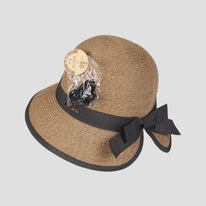Close-up of elegant sun hat texture with UPF 50+ tag and stylish black bow detail