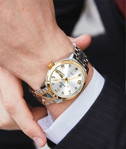 Detailed view of Poedagar luxury men's watch with gold-tone date display on wrist