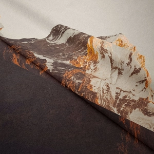 Detail of bohemian mountain print fabric showing thick flannel texture and folded edges