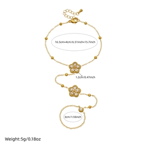 Gold eight-pointed star hand chain bracelet with white zircon flower on white background