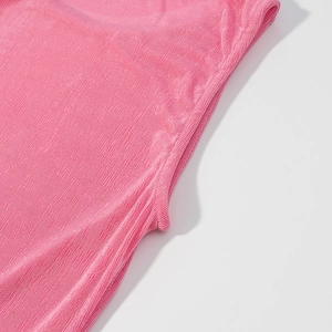 Close-up of pink knitted fabric texture with fine vertical stripes and stitching details