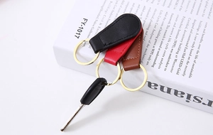 Detailed close-up of premium PU leather keychains with stitching and gold metal ring