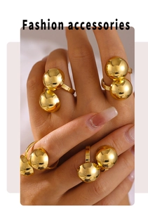 Close-up of fashion gold spherical rings with 18k gold plating on model's hand