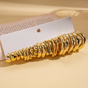 20-piece set of gold geometric hoop earrings on display card with retro background