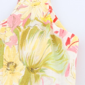 Close-up of summer linen dress featuring colorful floral print and breathable fabric texture