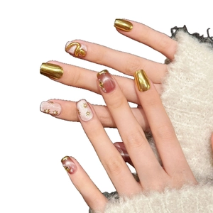 3D golden snake press-on nails with pink cat-eye finish and pearl accents for New Year
