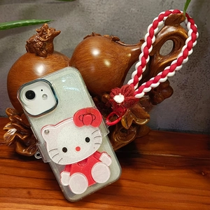 Close-up of glitter iPhone case with cartoon cat figure and braided wrist strap