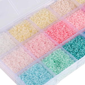 Close-up of macaron color glass seed beads organized in a 24-grid storage box for DIY