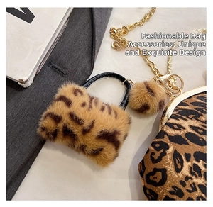 Detail of leopard print faux fur mini bag with woven handle and gold chain strap
