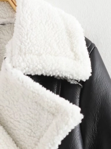 Detail of black leather and white shearling faux fur collar on a biker jacket