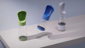 Portable pet water bottle in green, blue and ivory colors for outdoor dog feeding