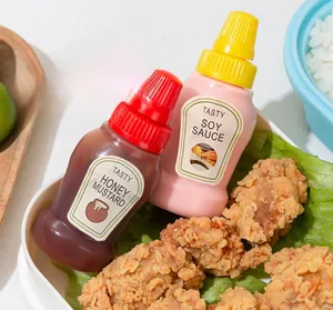 Mini portable sauce squeeze bottles with labels for honey mustard and soy sauce in bento box