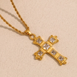 Close-up of 18K gold plated stainless steel cross necklace with square zircons
