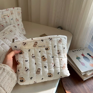 Quilted cotton hand pouch with cute animal prints held to show soft texture and size