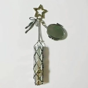 Detail view of silver metal keychain with star clasp, mirror pendant and lipstick mesh tube
