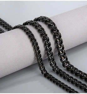 Detail of chunky black stainless steel Cuban link necklace with polished finish
