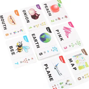 Macro shot of educational flashcards featuring animal, fruit, and number pairing for toddlers