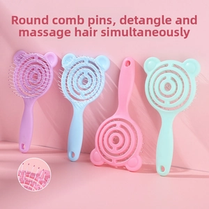 Close-up of flexible spiral vented hairbrush with massage bristles and bear design