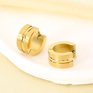Close-up of brushed gold stainless steel C-shape earrings on a white display tray