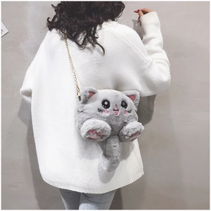 Detail view of a cute grey plush cat crossbody bag with a golden metal chain strap