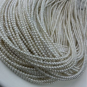 Macro shot of high-quality 6-7mm round white natural freshwater pearls with lustrous finish