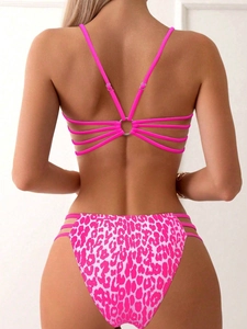 Detailed back view of pink leopard bikini featuring criss-cross straps and metal ring