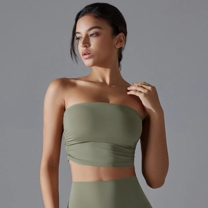 Close-up of ruched side detailing on breathable sage green yoga sports bra top