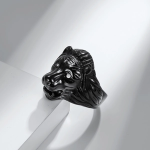 Polished black lion head ring for men with clear zircon eyes on white geometric stand