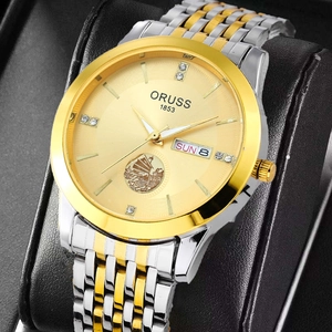 Macro detail of ORUSS gold quartz watch dial featuring sailboat logo and date display