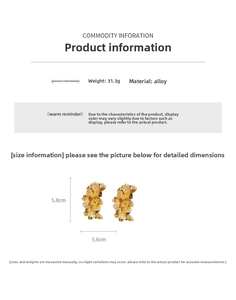 Detailed view of large golden alloy floral earrings with realistic metal leaf textures